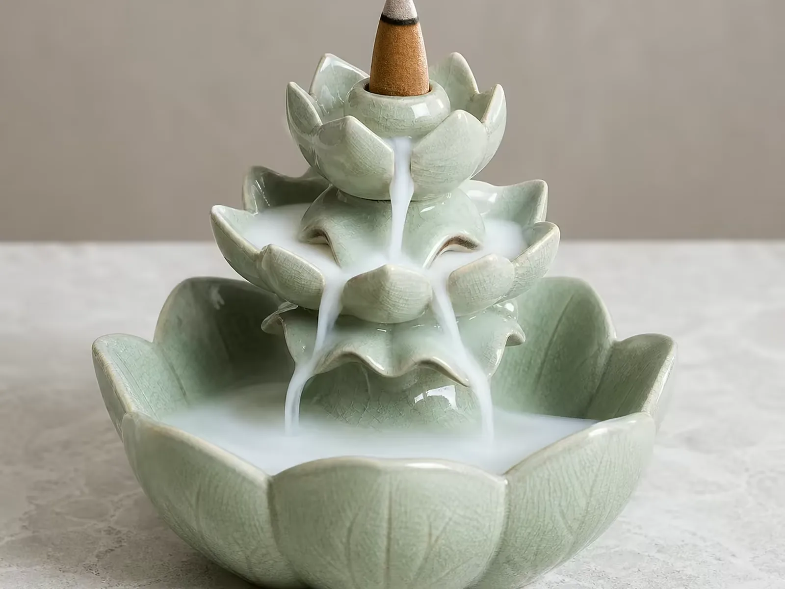 Celadon lotus backflow burner with smoke settling into the petal bowl