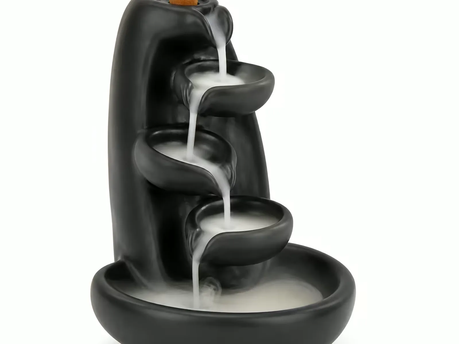 Matte black backflow incense burner on a plain background, cone seated at the top