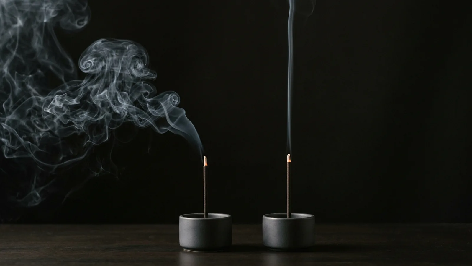 Two incense sticks burning side by side, one throwing black smoke and one clean — why does my incense keep going out, shown