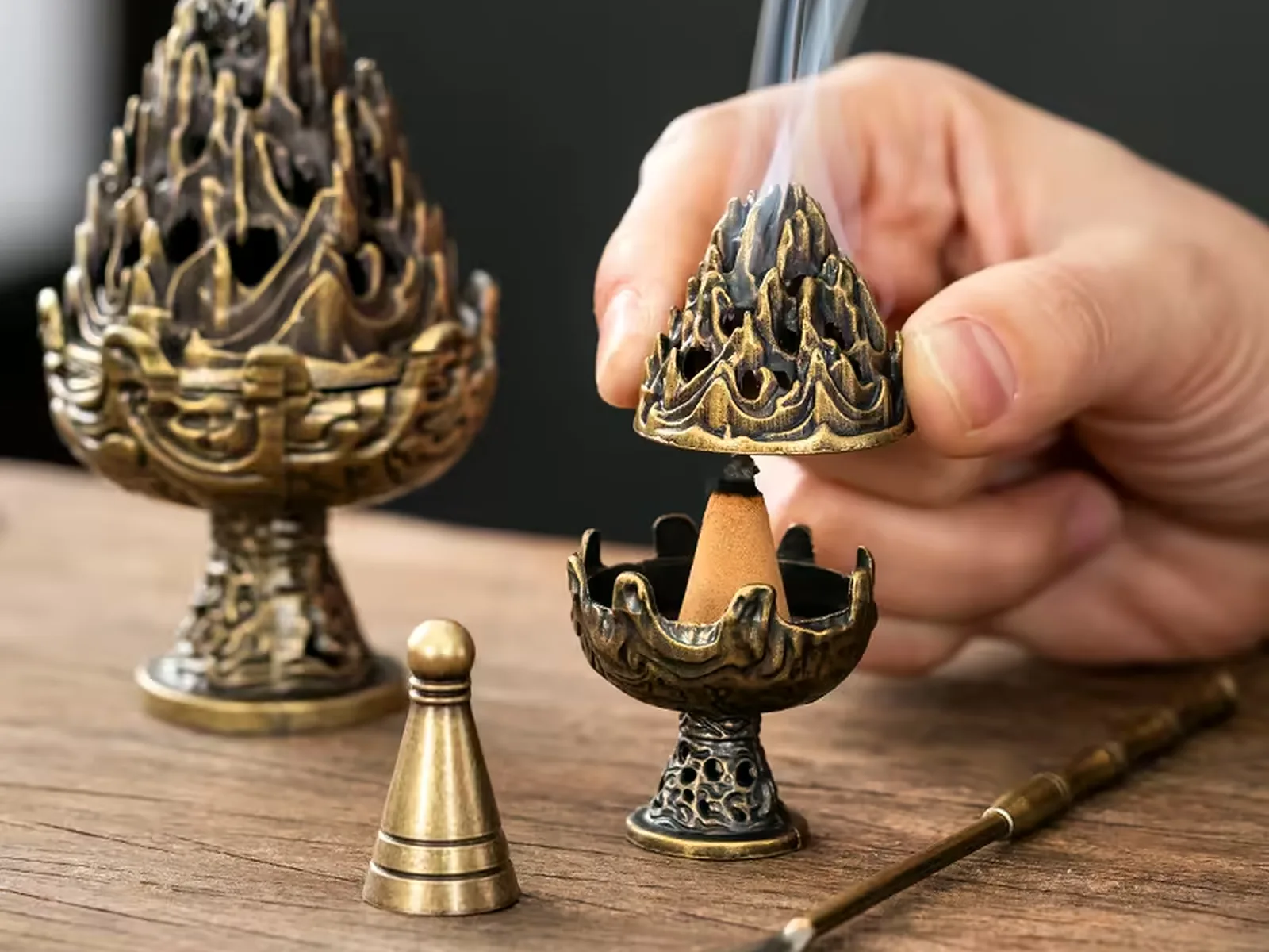 Brass lotus censers with the pierced lid lifted clear, brass tools alongside