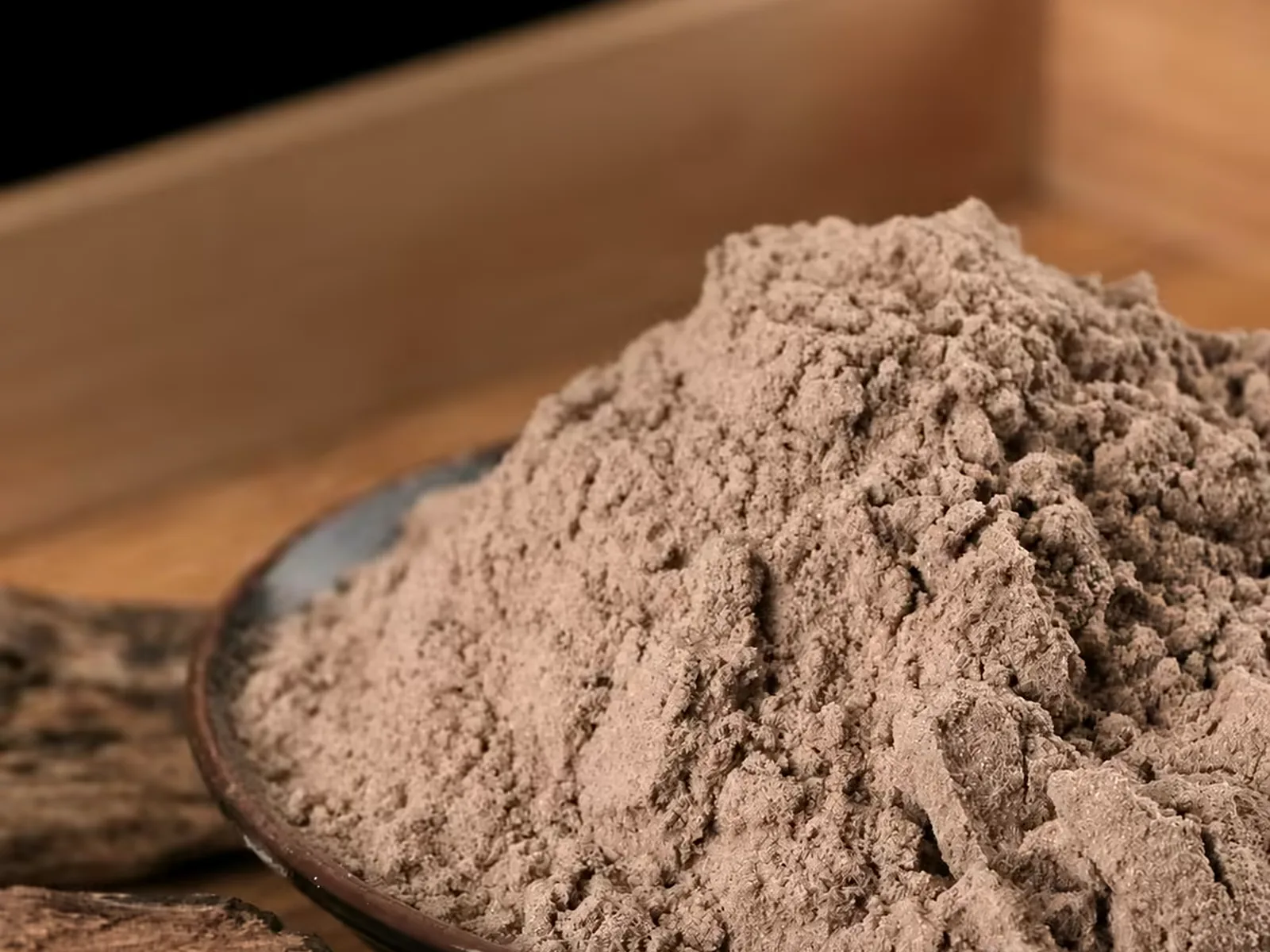 Close-up of agarwood incense powder showing an even, fine grain and uniform colour