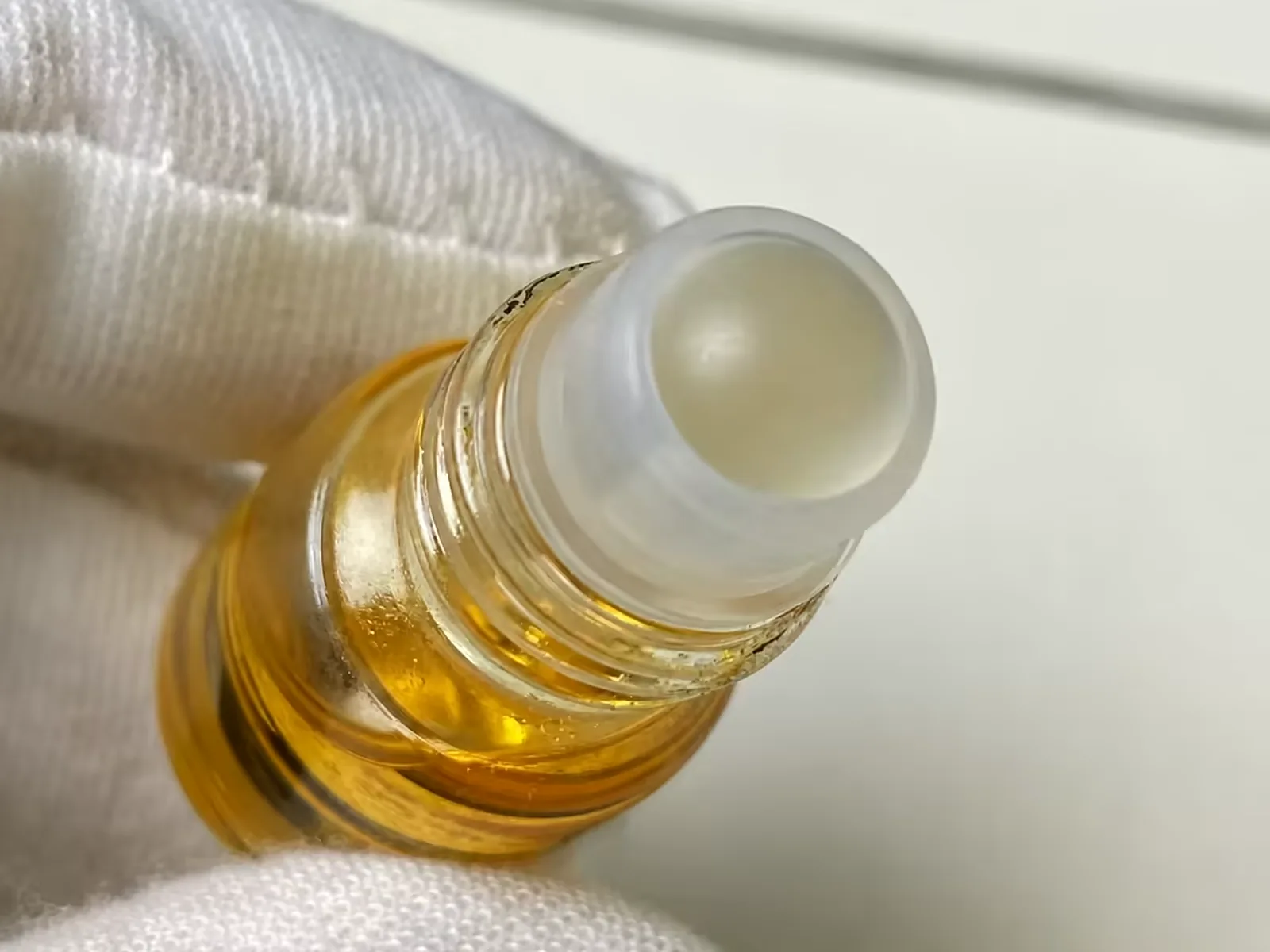 Close-up of the steel roller ball and its housing on a filled roll-on bottle