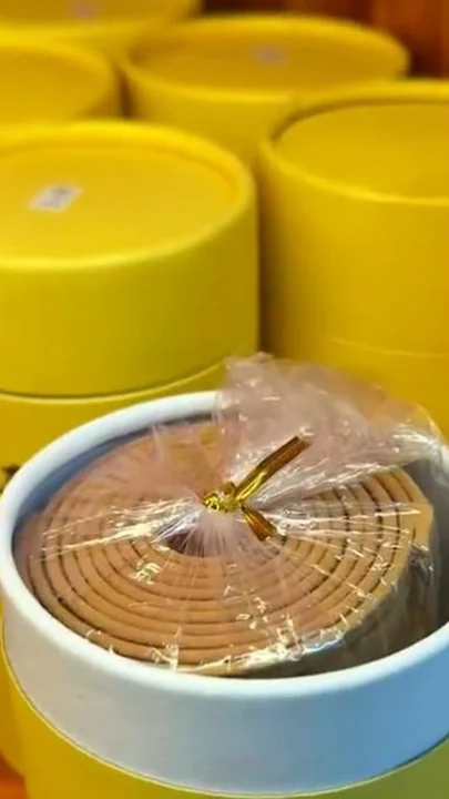 Coil incense sealed and stacked into retail packaging on the factory floor