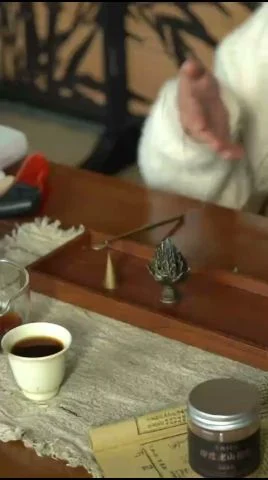 Fine agarwood powder alight in a burner, the way kinam oud material is normally assessed