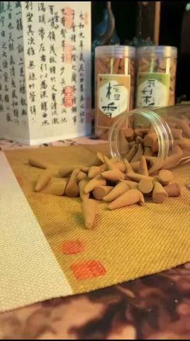 Oud incense cones being lit on a heat-resistant burner — how to burn incense, step by step