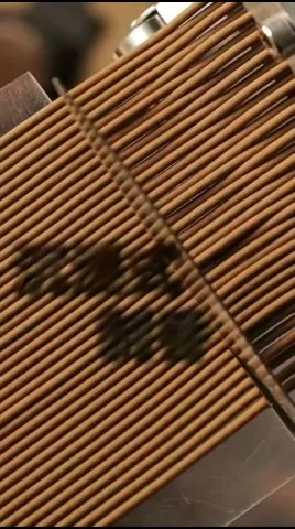 Joss sticks being pressed and straightened before going onto drying trays